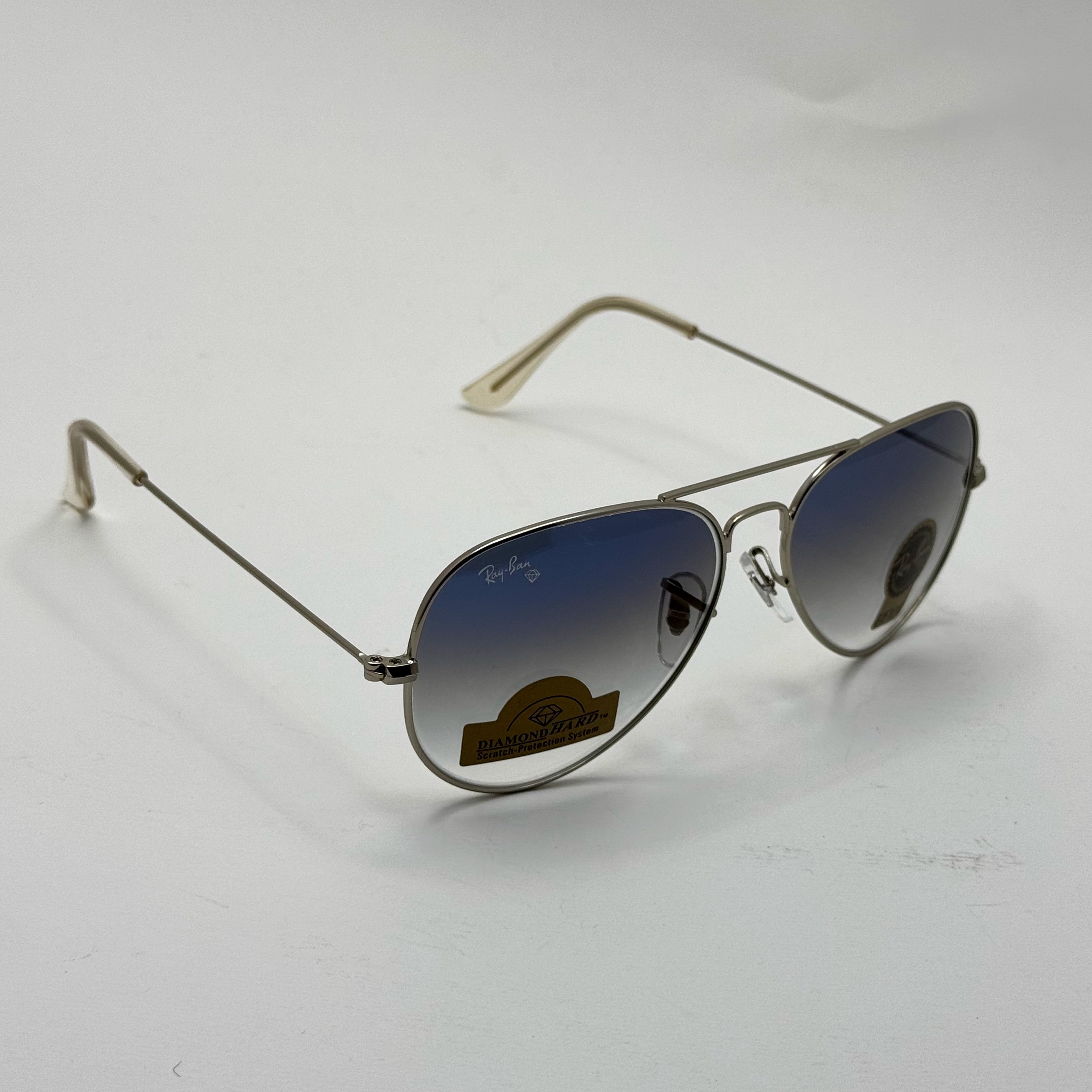 عینک ریبن خلبانی شیشه سنگ آبی هایلایت فریم نقره ای به همراه پک کامل ریبن کد Rayban RB 3025 (ارسال رایگان)
